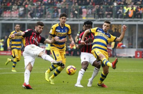 AC Milan's Patrick Cutrone, left, scores his side's opening goal during the Serie A soccer match between AC Milan and Parma at the San Siro Stadium, in Milan, Italy, Sunday, Dec. 2, 2018. (AP Photo/Antonio Calanni)