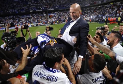 Real Madrid's head coach Zinedine Zidane is thrown into the air by his players after winning a Spanish La Liga soccer match between Malaga and Real Madrid in Malaga, Spain, Sunday, May 21, 2017. Real Madrid wins the Spanish league for the first time in five years, avoiding its biggest title drought since the 1980s. (AP Photo/Daniel Tejedor)