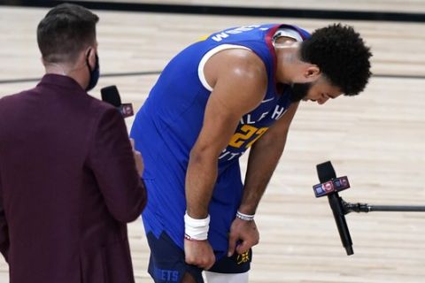 Denver Nuggets' Jamal Murray (27) becomes emotional during an interview after an NBA basketball first round playoff game against the Utah Jazz Sunday, Aug. 30, 2020, in Lake Buena Vista, Fla. The Nuggets won 119-107. (AP Photo/Ashley Landis)