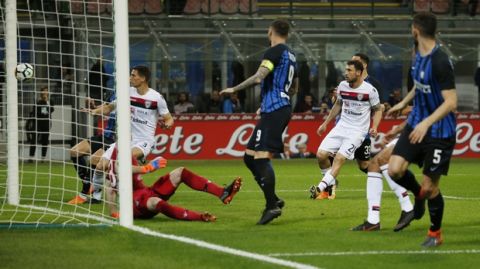The ball kicked by Inter Milan's Joao Cancelo, not in pic, enters the net for Inter's first goal during an Italian Serie A soccer match between Inter Milan and Cagliari, at the San Siro stadium in Milan, Italy, Tuesday, April 17, 2018. (AP Photo/Antonio Calanni)