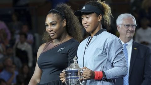 Serena Williams, left, and Naomi Osaka, of Japan, pose for photos during the trophy ceremony after Osaka defeated Williams in the women's finals of the U.S. Open tennis tournament at the USTA Billie Jean King National Tennis Center on Saturday, Sept. 8, 2018, in New York. (Photo by Greg Allen/Invision/AP)
