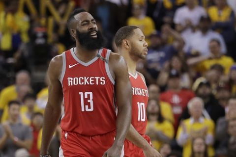 Houston Rockets guard James Harden (13) and guard Eric Gordon (10) react during the second half of Game 6 of the NBA basketball Western Conference Finals against the Golden State Warriors in Oakland, Calif., Saturday, May 26, 2018. (AP Photo/Marcio Jose Sanchez)