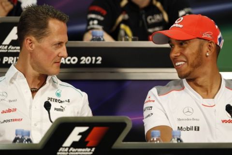 FILE - The May 23, 2012 file photo shows Mercedes Grand Prix driver Michael Schumacher of Germany, left, and McLaren Mercedes driver Lewis Hamilton of Britain during a news conference at the Monaco racetrack. Seven-time world champion Michael Schumacher is going to leave Mercedes at the end of the season as he is going to be replaced by Lewis Hamilton. (AP Photo/Luca Bruno, file)