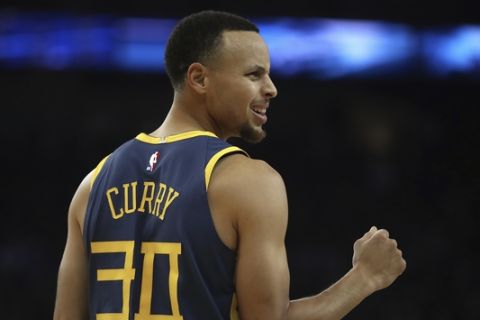 Golden State Warriors' Stephen Curry celebrates a score against the Memphis Grizzlies during the first half of an NBA basketball game Monday, Dec. 17, 2018, in Oakland, Calif. (AP Photo/Ben Margot)