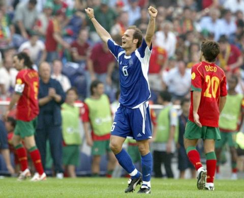 epa000210536 Greek player Angelis Basinas celebrates after the team defeated Portugal in the Group A match of the EURO 2004 at Estadio do Dragao in Porto, Saturday 12 June 2004.  Greece won 2-1.  At right is Portugal's Deco and far left captain Fernando Couto.  EPA/NUNO VEIGA NO MOBILEPHONE APPLICATIONS
