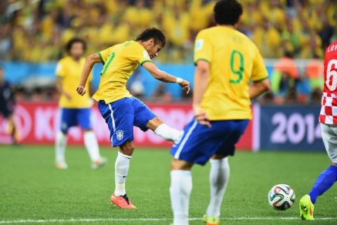 SAO PAULO, BRAZIL - JUNE 12: Neymar of Brazil shoots and scores in the first half during the 2014 FIFA World Cup Brazil Group A match between Brazil and Croatia at Arena de Sao Paulo on June 12, 2014 in Sao Paulo, Brazil.  (Photo by Buda Mendes/Getty Images)