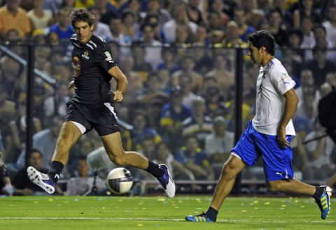Argentine tennis player Juan Martin del Potro (L) kicks the ball during Martin Palermo's farewell football match, at La Bombonera stadium in Buenos Aires, on February 4, 2012. AFP PHOTO / Alejandro PAGNI (Photo credit should read ALEJANDRO PAGNI/AFP/Getty Images)
