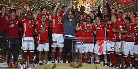 BERLIN, GERMANY - MAY 21:  Head coach Pep Guardiola of Bayern Muenchen lifts the trophy after winning the DFB Cup final match in a penalty shootout against Borussia Dortmund at Olympiastadion on May 21, 2016 in Berlin, Germany.  (Photo by Lars Baron/Bongarts/Getty Images)