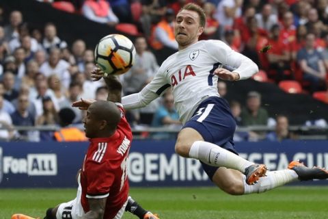 Tottenham's Christian Eriksen vies for the ball with Manchester United's Ashley Young, left, during the English FA Cup semifinal soccer match between Manchester United and Tottenham Hotspur at Wembley stadium in London, Saturday, April 21, 2018. (AP Photo/Kirsty Wigglesworth)