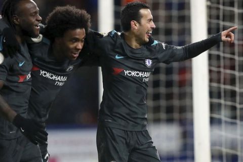 Chelsea's Rodriguez Pedro, right, celebrates scoring his sides third goal during their English Premier League soccer match against Huddersfield at the John Smith's Stadium, Huddersfield, England, Tuesday, Dec. 12, 2017. (Mike Egerton/PA via AP)