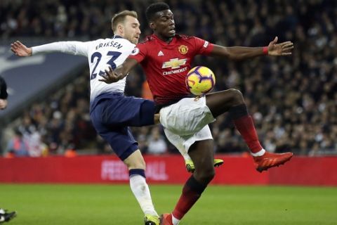 Tottenham's Christian Eriksen fights for the ball with Manchester United's Paul Pogba, right, during the English Premier League soccer match between Tottenham Hotspur and Manchester United at Wembley stadium in London, England, Sunday, Jan. 13, 2019. (AP Photo/Tim Ireland)