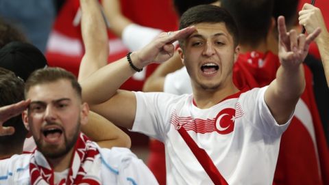 Turkish soccer team supporters shout slogans and salute before the Euro 2020 group H qualifying soccer match between France and Turkey at Stade de France at Saint Denis, north of Paris, France, Monday, Oct. 14, 2019. (AP Photo/Thibault Camus)