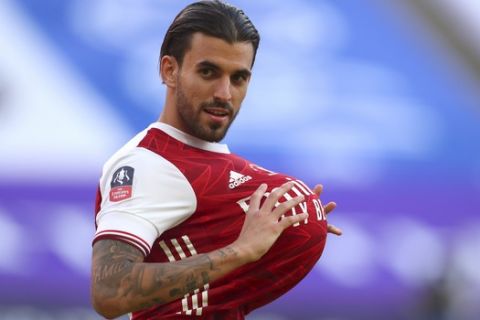 Arsenal's Dani Ceballos holds a ball under his shirt after the FA Cup final soccer match between Arsenal and Chelsea at Wembley stadium in London, England, Saturday, Aug.1, 2020. (Catherine Ivill/Pool via AP)