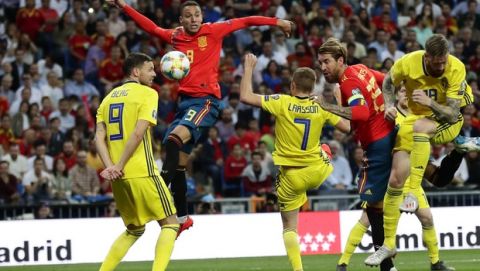 Spain's Rodrigo, center, jumps above Sweden's Marcus Berg, left and Sebastian Larsson during the Euro 2020 Group F qualifying soccer match between Spain and Sweden at the Santiago Bernabeu stadium in Madrid, Monday June 10, 2019. (AP Photo/Manu Fernandez)