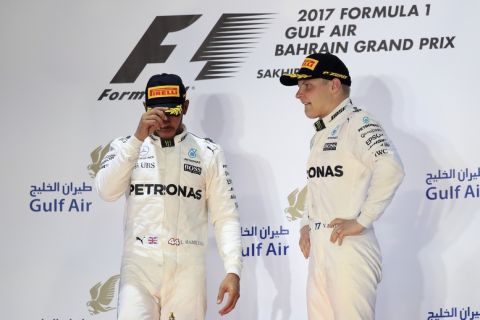Mercedes driver Lewis Hamilton of Britain, left, and Mercedes driver Valtteri Bottas of Finland stand on the podium after the Bahrain Formula One Grand Prix, at the Formula One Bahrain International Circuit in Sakhir, Bahrain, Sunday, April 16, 2017. Hamilton finished second and Bottas was third. (AP Photo/Hassan Ammar)