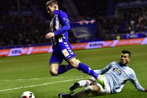 Alaves's Theo Hernandez, left, duels for the ball with Celta's Gustavo Cabral during the Spanish Copa del Rey semifinal, second leg soccer match between Alaves and Celta, at Mendizorroza stadium, in Vitoria, northern Spain, Wednesday, Feb. 8, 2017. (AP Photo/Alvaro Barrientos)