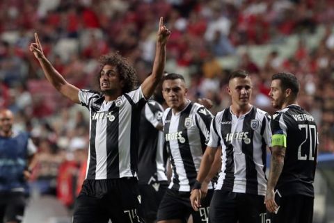 PAOK's Amr Warda, left, celebrates scoring his side's first goal during the Champions League playoffs, first leg, soccer match between Benfica and PAOK at the Luz stadium in Lisbon, Tuesday, Aug. 21, 2018. (AP Photo/Armando Franca)