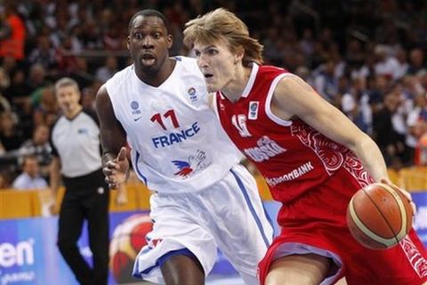 Andrei Kirilenko, right, of Russia is challenged by Florent Pietrus from France during the EuroBasket 2011, European Basketball Championships semi final match in Kaunas, Lithuania, Friday, Sept. 16, 2011. (AP Photo/Mindaugas Kulbis)
