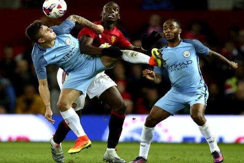 Manchester United's Paul Pogba, centre, challenges for the ball with Manchester City's Pablo Maffeo, left, and Manchester City's Raheem Sterling during the English League Cup soccer match between Manchester United and Manchester City at Old Trafford stadium in Manchester, England, Wednesday, Oct. 26, 2016. (AP Photo/Dave Thompson)