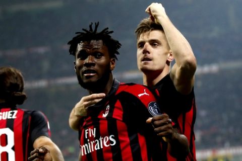 AC Milan's Franck Kessie, left, celebrates with his teammate Krzysztof Piatek after scoring his side's second goal during the Serie A soccer match between AC Milan and Empoli at the San Siro stadium, in Milan, Italy, Friday, Feb. 22, 2019. (AP Photo/Antonio Calanni)