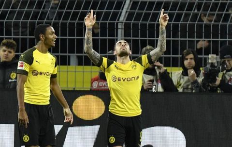 Dortmund's Paco Alcacer, right, celebrates after scoring his side's second goal in the last minute during the German Bundesliga soccer match between Borussia Dortmund and SC Freiburg in Dortmund, Germany, Saturday, Dec. 1, 2018. (AP Photo/Martin Meissner)