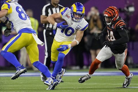 Los Angeles Rams wide receiver Cooper Kupp (10) runs past Cincinnati Bengals strong safety Vonn Bell, right, for a first down during the second half of the NFL Super Bowl 56 football game Sunday, Feb. 13, 2022, in Inglewood, Calif. (AP Photo/Marcio Jose Sanchez)