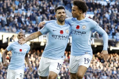 Manchester City's Sergio Aguero, left, celebrates scoring his side's second goal of the game during the English Premier League soccer match between Manchester City and Arsenal, at the Etihad Stadium, in Manchester, Sunday, Nov. 5, 2017. (Martin Rickett/PA via AP)