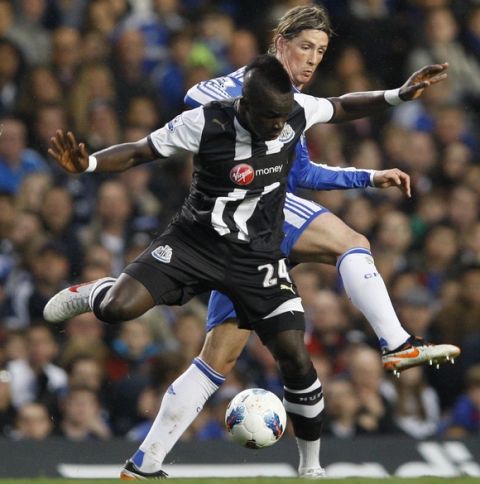 Chelsea's Fernando Torres, behind, vies for the ball with Newcastle's Cheick Tiote during the English Premier League soccer match between Chelsea and Newcastle United at Stamford Bridge Stadium in London, Wednesday, May 2, 2012. (AP Photo/Kirsty Wigglesworth) 