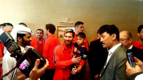 In this Tuesday Dec. 13, 2016 photo released by The Supreme Committee for Delivery & Legacy, SC, Lionel Messi poses with Murtaza Ahmady, wearing a Barcelona jersey, from Afghanistan in Doha, Qatar. In a meeting arranged by the organizing committee of the 2022 World Cup in Qatar, Messi held hands with Murtaza at the team hotel before picking up the boy and posing for photographs. (The Supreme Committee for Delivery & Legacy, SC via AP)