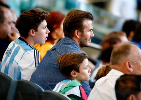 RIO DE JANEIRO, BRAZIL - JULY 13: (L-R) Brooklyn Beckham, former England international David Beckham and Romeo Beckham look on during the 2014 FIFA World Cup Brazil Final match between Germany and Argentina at Maracana on July 13, 2014 in Rio de Janeiro, Brazil.  (Photo by Jamie Squire/Getty Images)