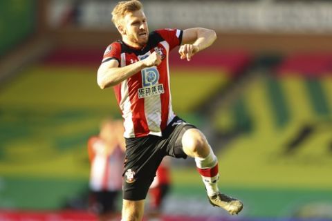 Southampton's Stuart Armstrong celebrates after scoring his side's second goal during the English Premier League soccer match between Norwich City and Southampton at Carrow Road in Norwich, England, Friday, June 19, 2020. (AP Photo/Richard Heathcote/Pool)