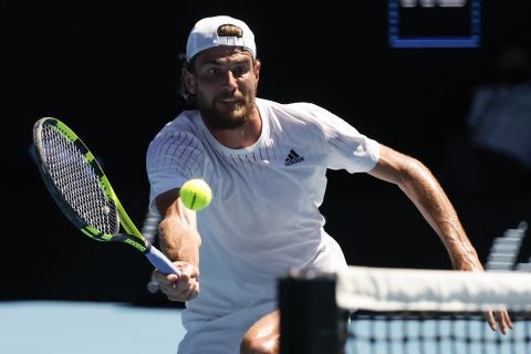 Maxime Cressy of the U.S. makes a forehand return to Daniil Medvedev of Russia during their fourth round match at the Australian Open tennis championships in Melbourne, Australia, Monday, Jan. 24, 2022. (AP Photo/Hamish Blair)