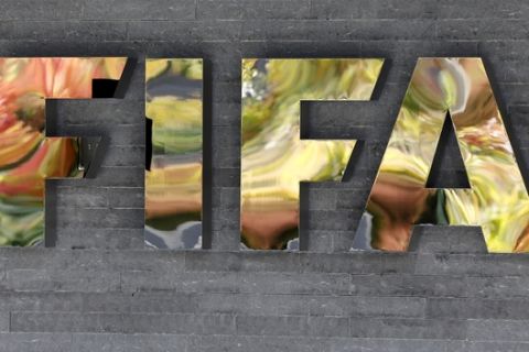 FILE - In this Sept. 25, 2015 file picture the FIFA logo is  pictured on a wall of the FIFA headquarters during a meeting of the FIFA Executive Committee in Zurich, Switzerland  while autumnal colors reflecting .  FIFA's ethics committee has asked for sanctions against Sepp Blatter and Michel Platini after finishing investigations into their alleged financial wrongdoing. FIFA President Blatter and UEFA President Platini now face bans of several years at full hearings before FIFA ethics judge Joachim Eckert, likely in December.  . (AP Photo/Michael Probst)