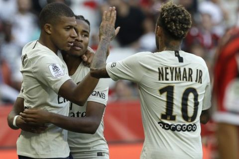 Paris Saint Germain's Christopher Nkunku, center , celebrates with Paris Saint Germain's Neymar, right, and Kylian Mbappe, after scoring his side's second goal, during the League One soccer match between Nice and Paris Saint-Germain at the Allianz Riviera stadium in Nice, southern France, Saturday, Sept. 29, 2018. (AP Photo/Claude Paris)