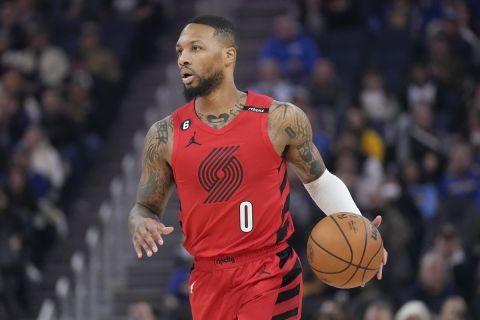 Portland Trail Blazers guard Damian Lillard (0) brings the ball up the court against the Golden State Warriors during the first half of an NBA basketball game in San Francisco, Tuesday, Feb. 28, 2023. (AP Photo/Jeff Chiu)