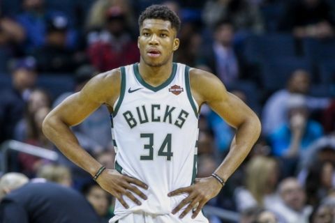Milwaukee Bucks forward Giannis Antetokounmpo, of Greece, stands on the court during a break in the action against the Charlotte Hornets in the second half of an NBA basketball game in Charlotte, N.C., Monday, Nov. 26, 2018. Charlotte won 110-107. (AP Photo/Nell Redmond)