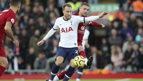 Tottenham's Christian Eriksen, left, challenges for the ball with Liverpool's Jordan Henderson during the English Premier League soccer match between Liverpool and Tottenham Hotspur at Anfield stadium in Liverpool, England, Sunday, Oct. 27, 2019. (AP Photo/Jon Super)