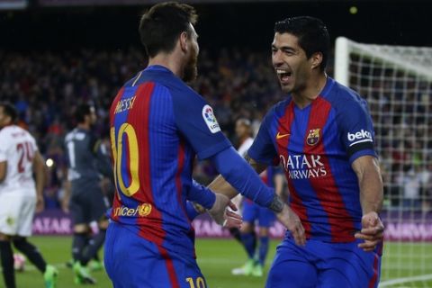 FC Barcelona's Luis Suarez, right, celebrates with his teammate Lionel Messi after scoring during the Spanish La Liga soccer match between FC Barcelona and Sevilla at the Camp Nou stadium in Barcelona, Spain, Wednesday, April 5, 2017. (AP Photo/Manu Fernandez)