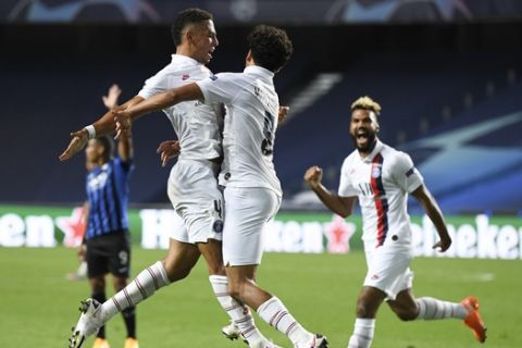 PSG's Marquinhos, centre, celebrates with teammate Thilo Kehrer, left, after scoring his team's first goal during the Champions League quarterfinal match between Atalanta and PSG at Luz stadium, Lisbon, Portugal, Wednesday, Aug. 12, 2020. (David Ramos/Pool Photo via AP)