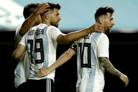 Argentina's Lionel Messi is congratulated by teammates Sergio Aguero and Eduardo Salvio after he scored during a friendly soccer match between Argentina and Haiti in Buenos Aires, Argentina, Tuesday, May 29, 2018. (AP Photo/Victor R. Caivano)