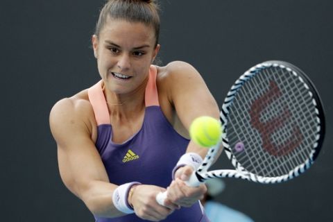 Greece's Maria Sakkari makes a backhand return to Japan's Nao Hibino during their second round singles match at the Australian Open tennis championship in Melbourne, Australia, Wednesday, Jan. 22, 2020. (AP Photo/Andy Wong)