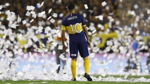Carlos Tevez of Boca Juniors stands amidst flying papers prior to the Copa Libertadores semifinal second leg soccer match against River Plate at La Bombonera stadium in Buenos Aires, Argentina, Tuesday, Oct. 22, 2019. (AP Photo/Natacha Pisarenko)