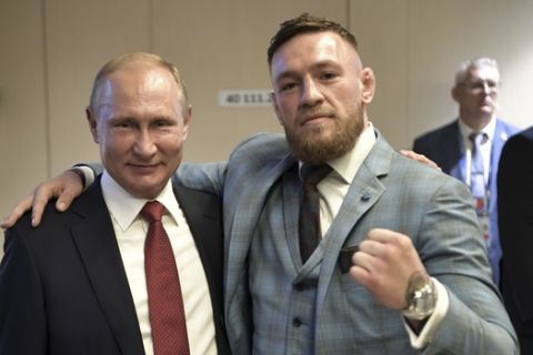 Russian President Vladimir Putin, left, and Ultimate fighting star Conor McGregor pose for a photo during the final match between France and Croatia at the 2018 soccer World Cup in the Luzhniki Stadium in Moscow, Russia, Sunday, July 15, 2018. (Alexei Nikolsky, Sputnik, Kremlin Pool Photo via AP)