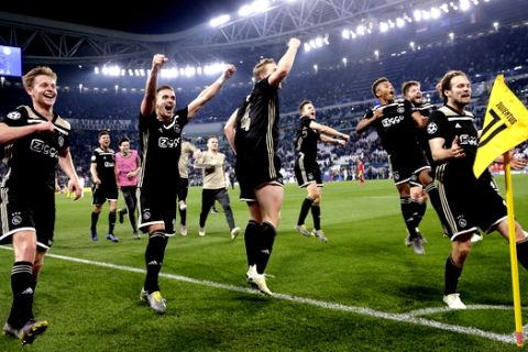 Ajax player celebrate at the end of the Champions League, quarterfinal, second leg soccer match between Juventus and Ajax, at the Allianz stadium in Turin, Italy, Tuesday, April 16, 2019. Ajax won 2-1 and advances to the semifinal on a 3-2 aggregate. (AP Photo/Luca Bruno)