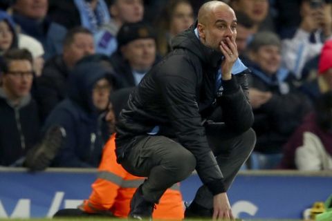 Manchester City's head coach Pep Guardiola reacts after a missed chance to score during the English League Cup semifinal second leg soccer match between Manchester City and Manchester United at Etihad stadium in Manchester, England, Wednesday, Jan. 29, 2020. (AP Photo/Dave Thompson)
