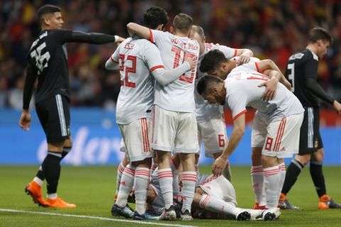 Spain players celebrate after Diego Costa, injured on the pitch, scored his side's first goal during the international friendly soccer match between Spain and Argentina at the Wanda Metropolitano stadium in Madrid, Spain, Tuesday, March 27, 2018. (AP Photo/Francisco Seco)