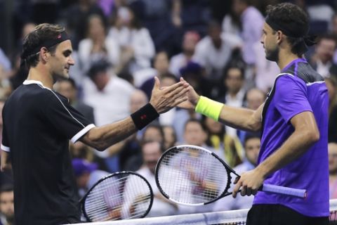 Grigor Dimitrov, of Bulgaria, right, shakes hands with Roger Federer, of Switzerland, after a quarterfinal of the U.S. Open tennis tournament Tuesday, Sept. 3, 2019, in New York. Dimitrov won 3-6, 6-4, 6-3, 6-4, 6-2. (AP Photo/Charles Krupa)