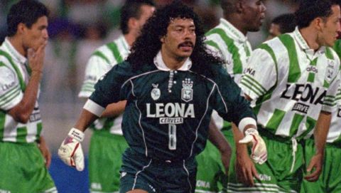 Colombian goalkeeper Rene Higuita leads his team, Nacional of Medellin, into the Medellin Stadium field to face Argentina's River Plate in a Supercopa game, Wednesday, Sept. 18, 1996. Nacional won 2-1 and qualified to the next leg of the South American tournement. (AP Photo/Ricardo Mazalan)