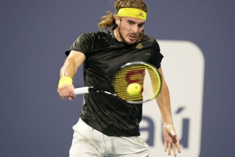 Stefanos Tsitsipas, of Greece, returns a shot from Lorenzo Sonego, of Italy, during the Miami Open tennis tournament, Tuesday, March 30, 2021, in Miami Gardens, Fla. (AP Photo/Wilfredo Lee)