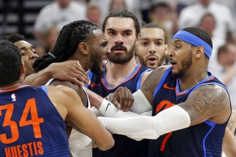 Utah Jazz forward Jae Crowder, left, and Oklahoma City Thunder forward Carmelo Anthony, right, are separated in the second half during Game 4 of an NBA basketball first-round playoff series, Monday, April 23, 2018, in Salt Lake City. Crowder was ejected from the game. Utah went on to win 113-96. (AP Photo/Rick Bowmer)